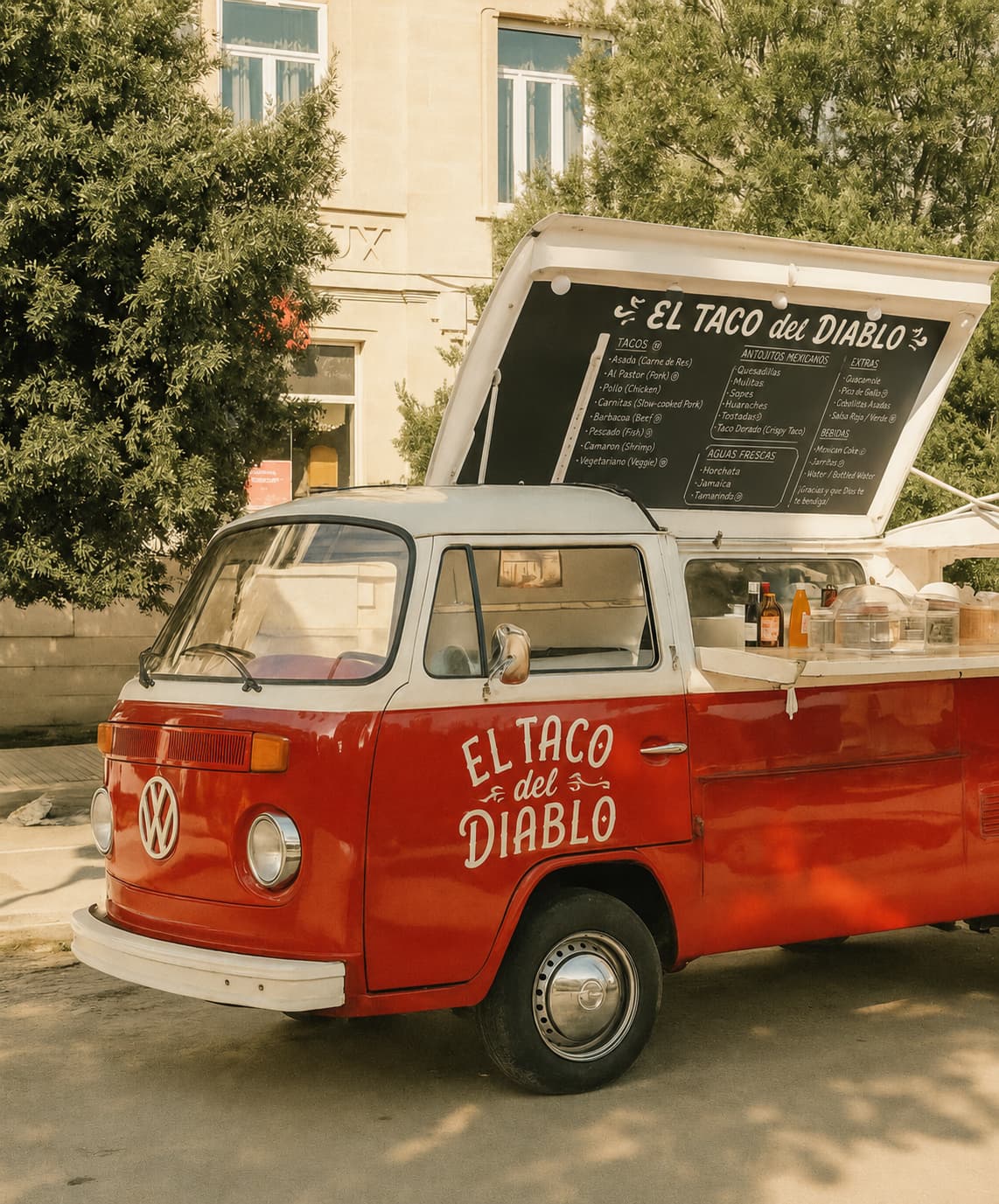 Turquoise VW T2 with hatch open and woman serving sandwiches on chalkboard counter